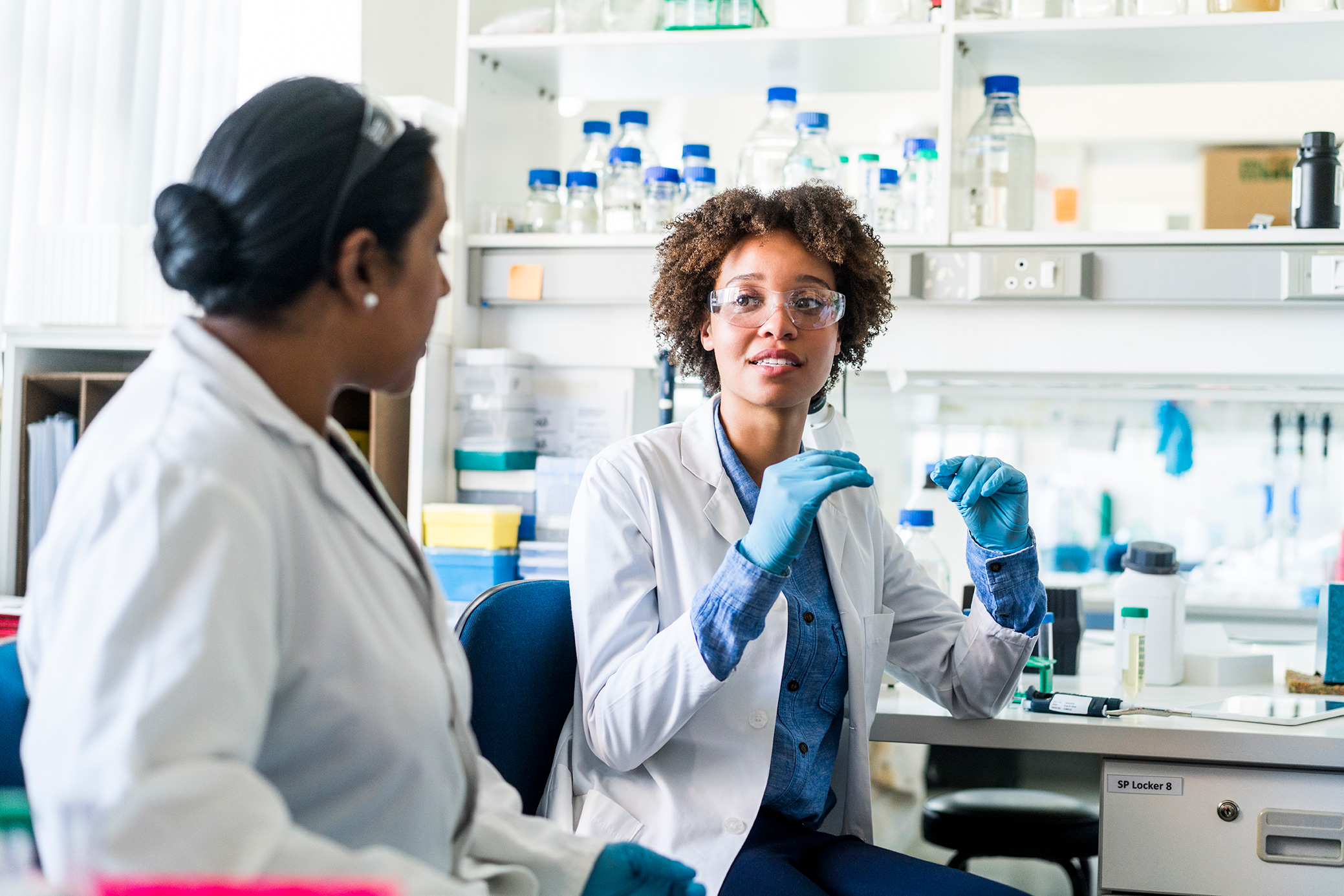 two women in lab discussing genetic services
